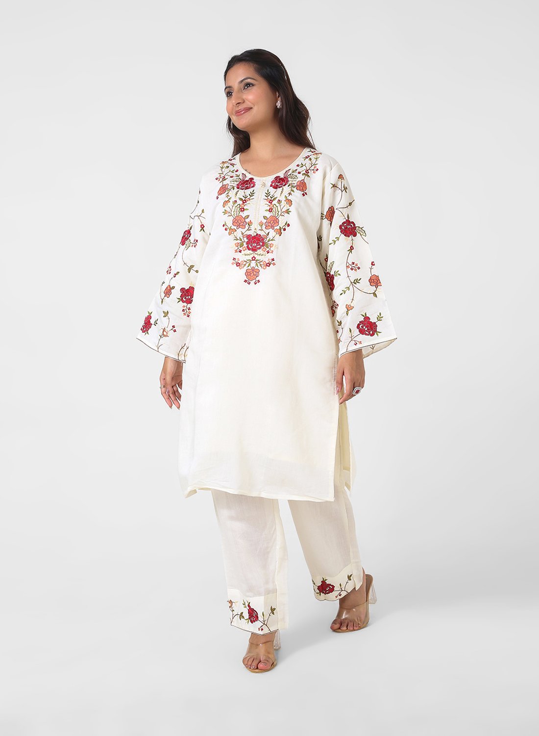 ivory floral embroidered kurta set, cotton kurta pants for women, multicolor threadwork kurta, breathable summer ethnic wear, straight fit kurta set, embroidered sleeve kurta, elegant daytime Indian suit.